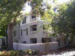 700 Bishops Park Drive Raleigh, NC 27605 - Photo 1 of 1 a view of house with outdoor seating and covered with trees