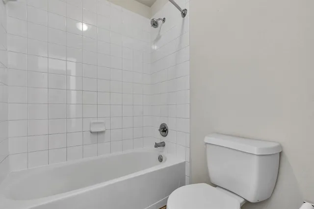 a bathroom with a toilet and bathtub