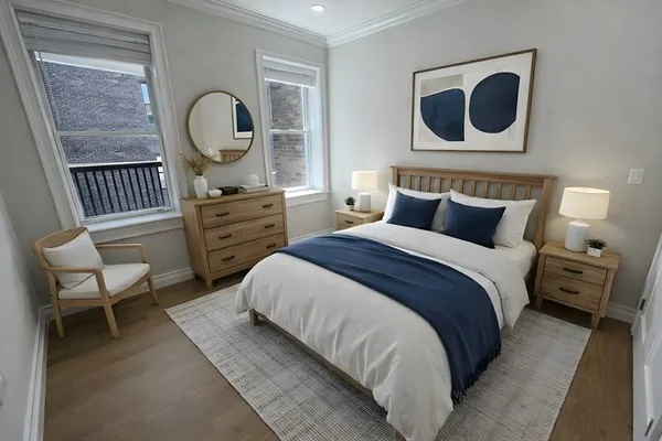 a bedroom with a bed and dresser with mirror