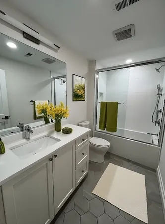 a bathroom with a sink a toilet and mirror