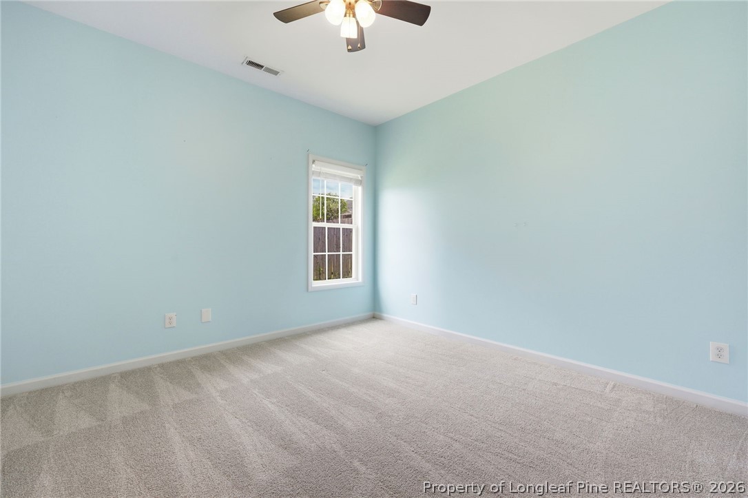 33 Colonist Place Cameron, NC 28326 - Photo 32 of 47 an empty room with a window and a ceiling fan