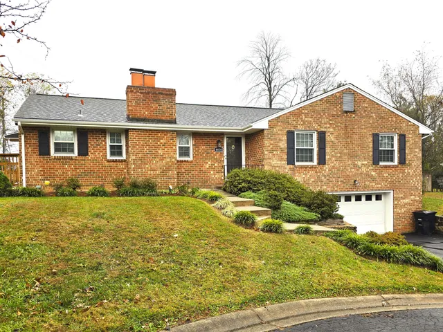 a front view of a house with yard and garage