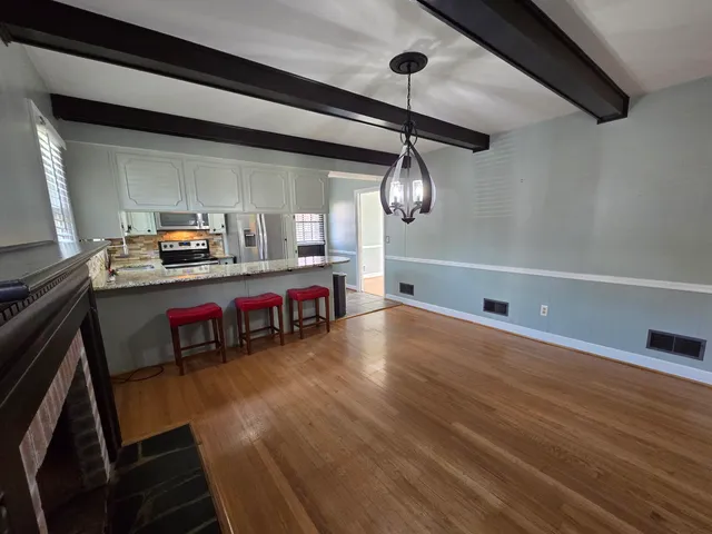 a view of a room with wooden floor and staircase