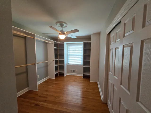 a view of an empty room with a fireplace and a window