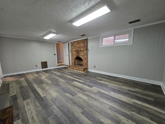 a view of empty room with a fireplace