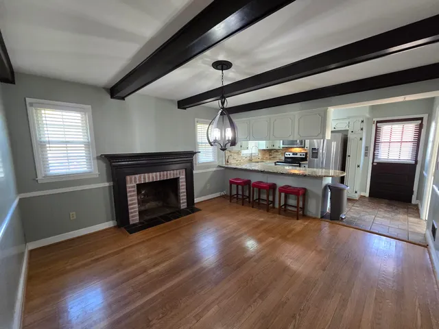 a living room with fireplace furniture and a fireplace