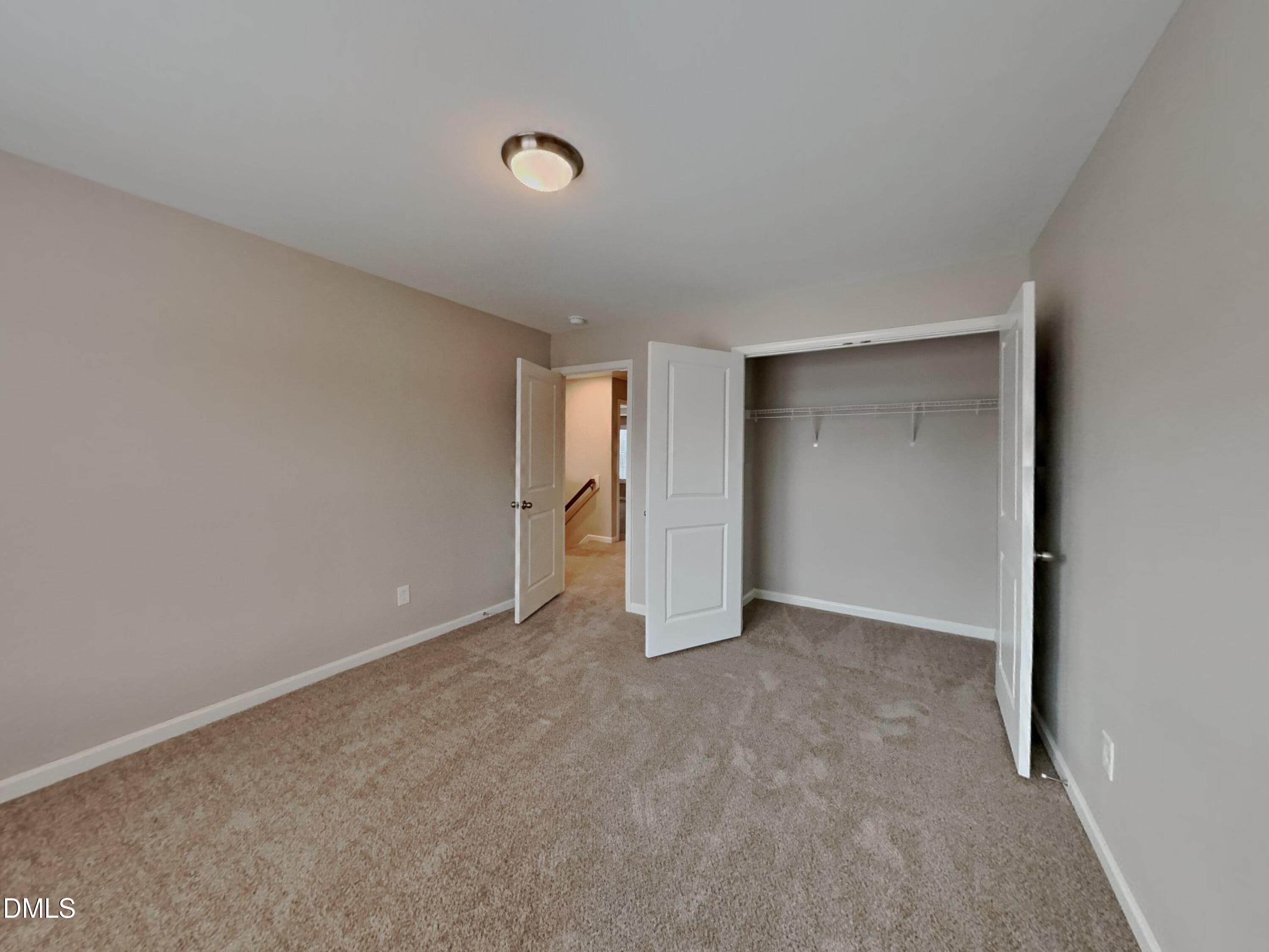 803 Springtooth Drive Zebulon, NC 27597 - Photo 12 of 16 a view of an empty room with a window