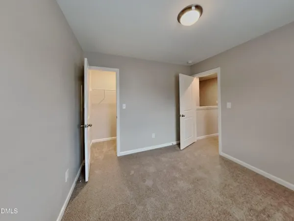 an empty room with closet area