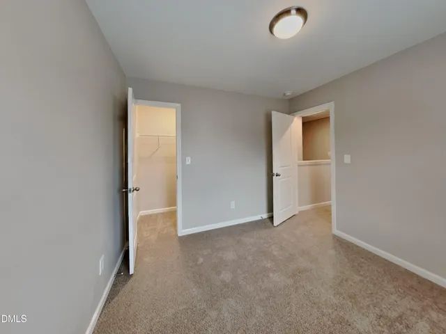 an empty room with closet area