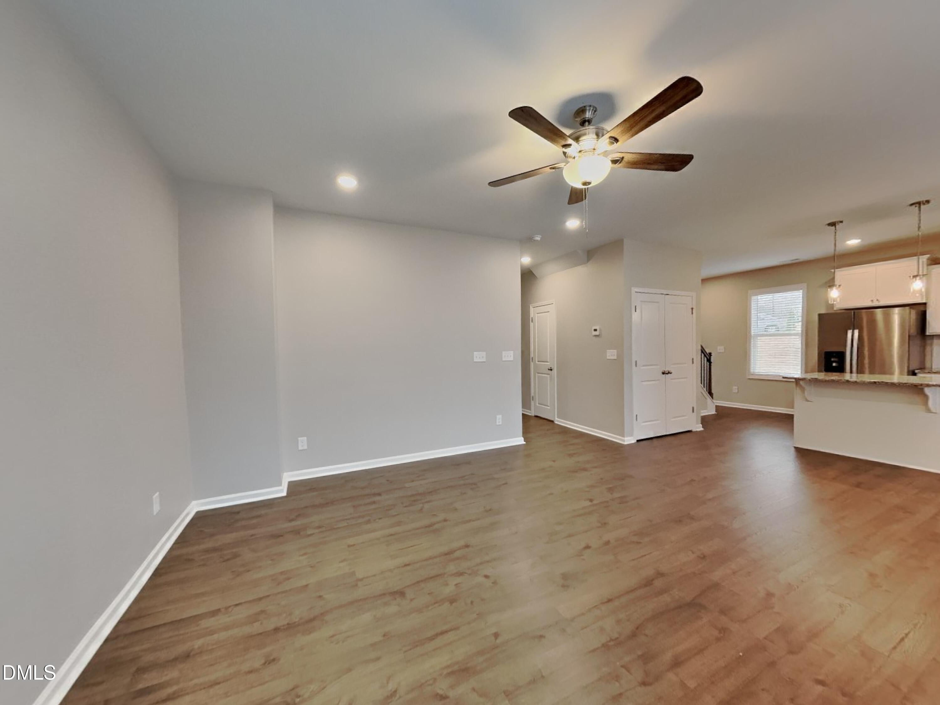 803 Springtooth Drive Zebulon, NC 27597 - Photo 2 of 16 a view of an empty room with a ceiling fan and window