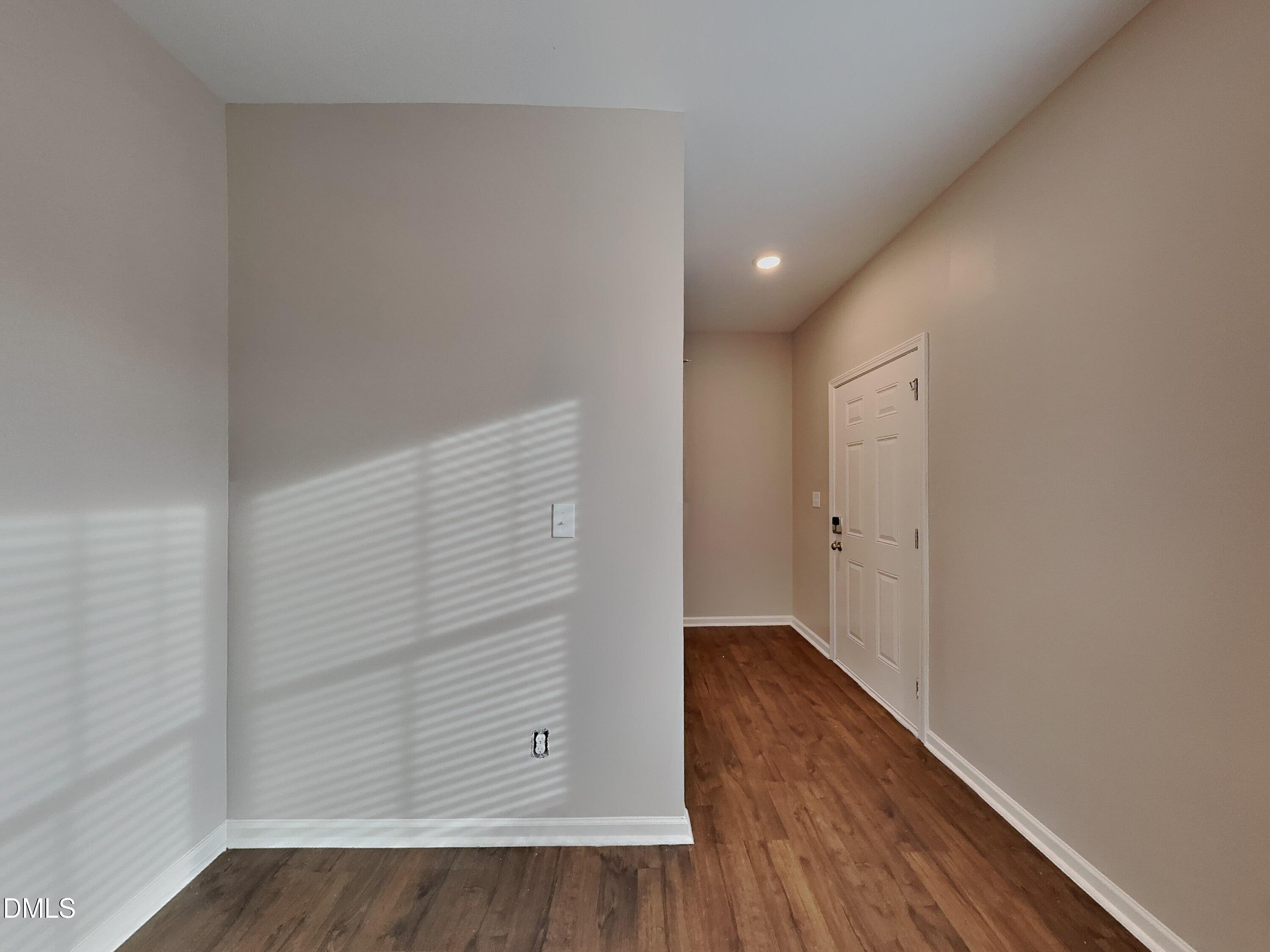 803 Springtooth Drive Zebulon, NC 27597 - Photo 3 of 16 a view of an empty room with wooden floor