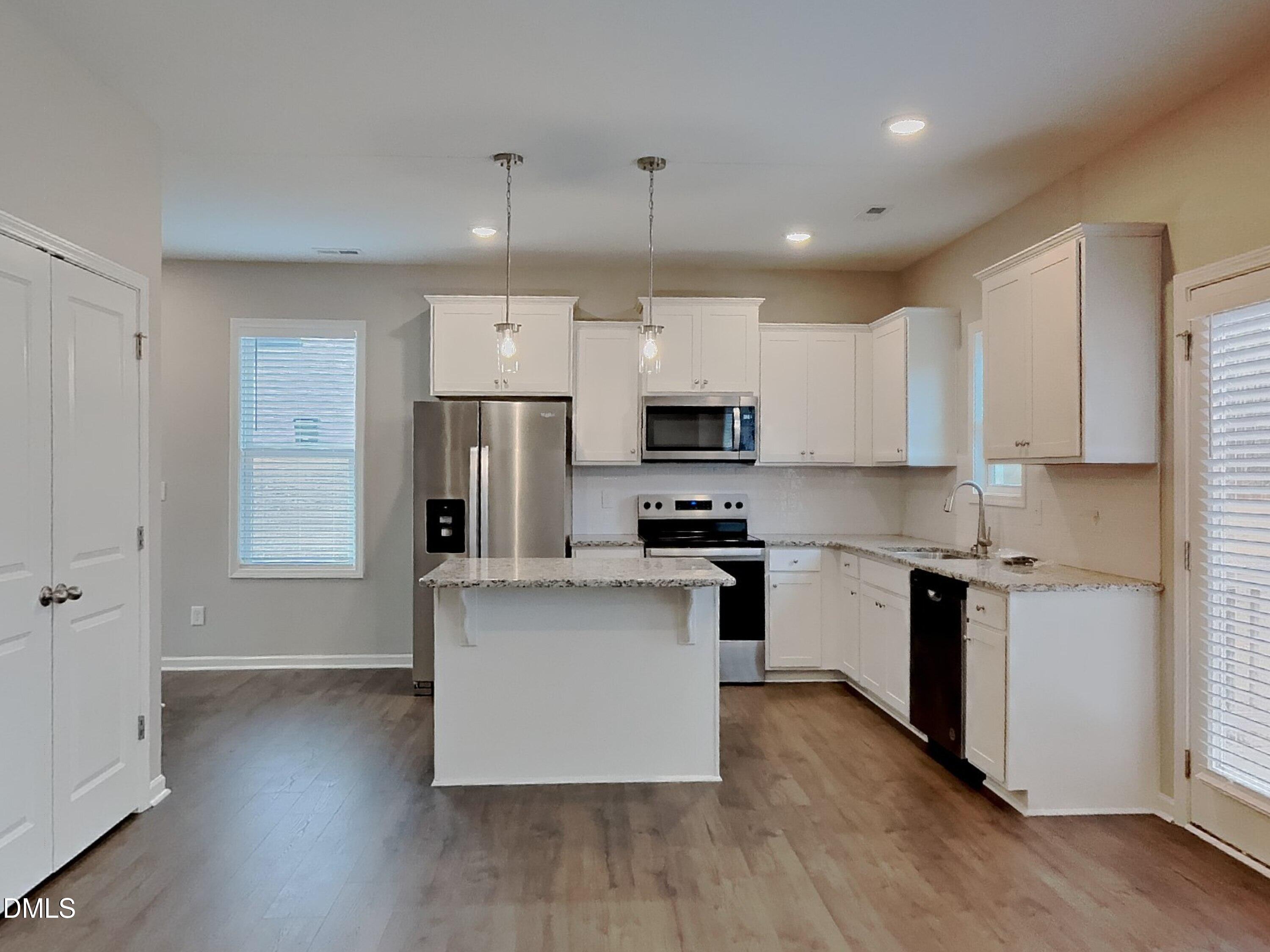 803 Springtooth Drive Zebulon, NC 27597 - Photo 4 of 16 a kitchen with stainless steel appliances a refrigerator sink and microwave