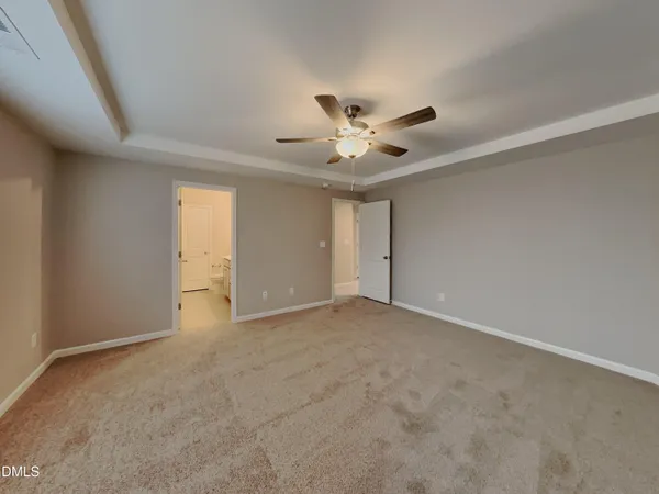 an empty room with a empty space and a ceiling fan