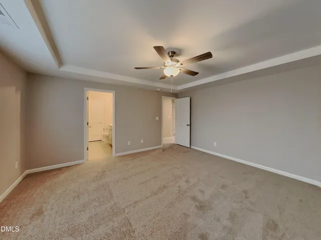 an empty room with a empty space and a ceiling fan