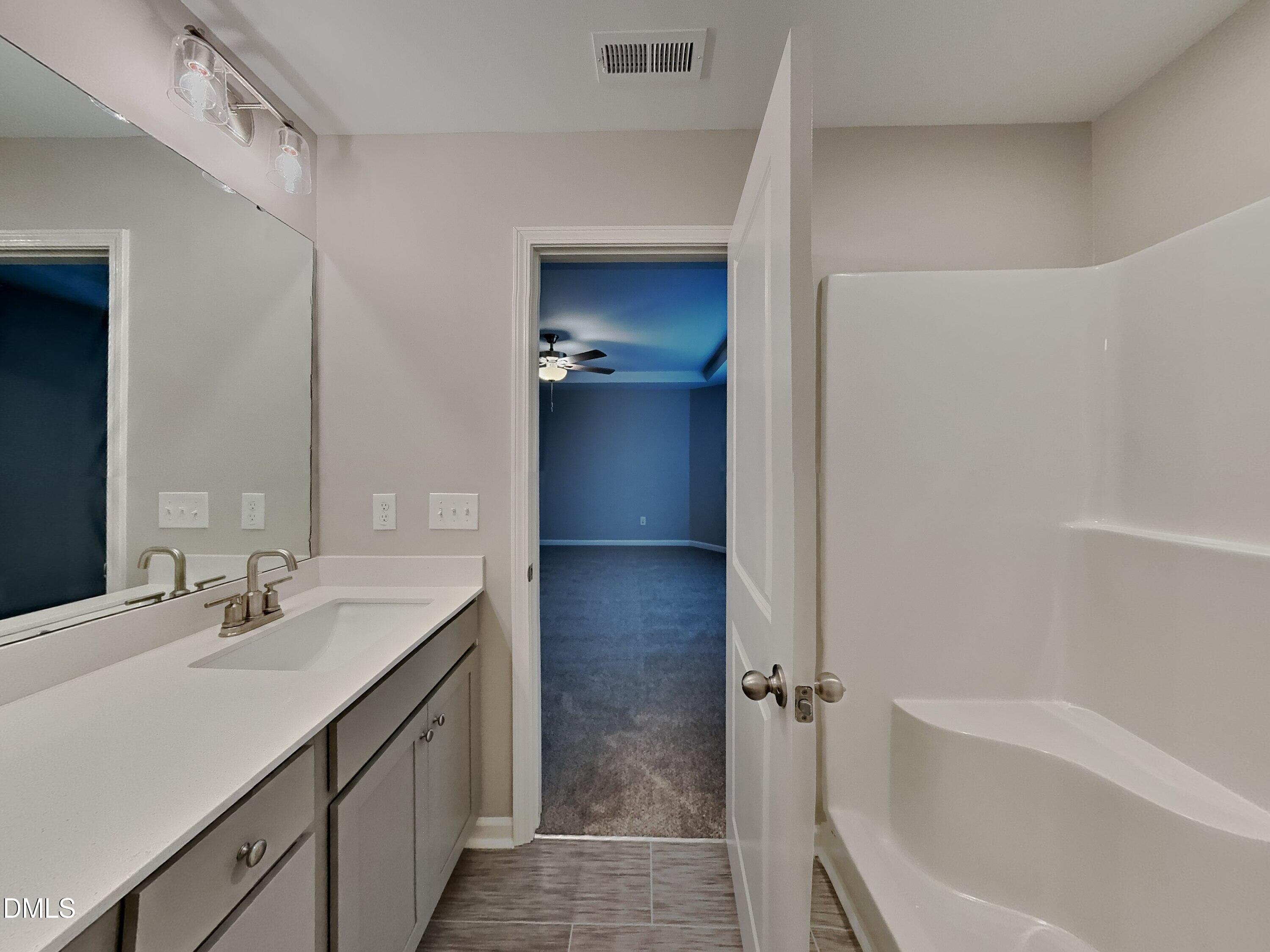 803 Springtooth Drive Zebulon, NC 27597 - Photo 7 of 16 a bathroom with a bathtub and a sink