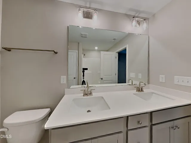 a bathroom with a sink toilet and mirror