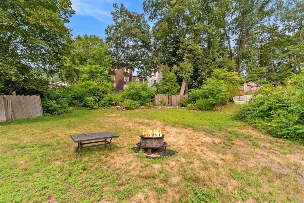 40 Nashua Street, Unit 5 Clinton, MA 01510 - Photo 8 of 33 a view of a patio with table and chairs a barbeque with wooden fence