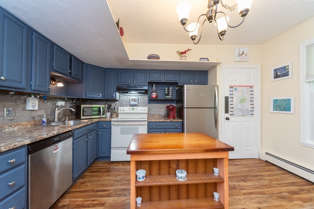 40 Nashua Street, Unit 5 Clinton, MA 01510 - Photo 9 of 33 a kitchen with stainless steel appliances granite countertop a sink a stove and a wooden floors