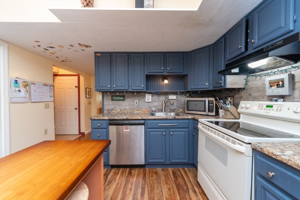 40 Nashua Street, Unit 5 Clinton, MA 01510 - Photo 10 of 33 a kitchen with stainless steel appliances granite countertop sink stove refrigerator and cabinets