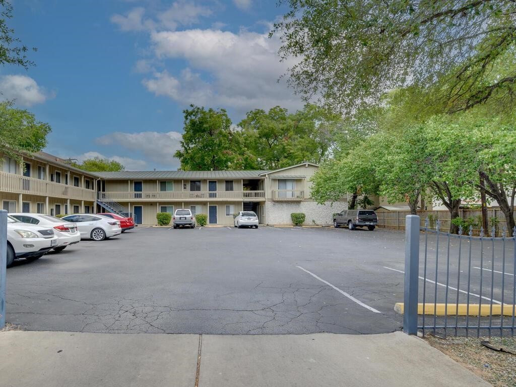 a couple of cars parked in front of a building