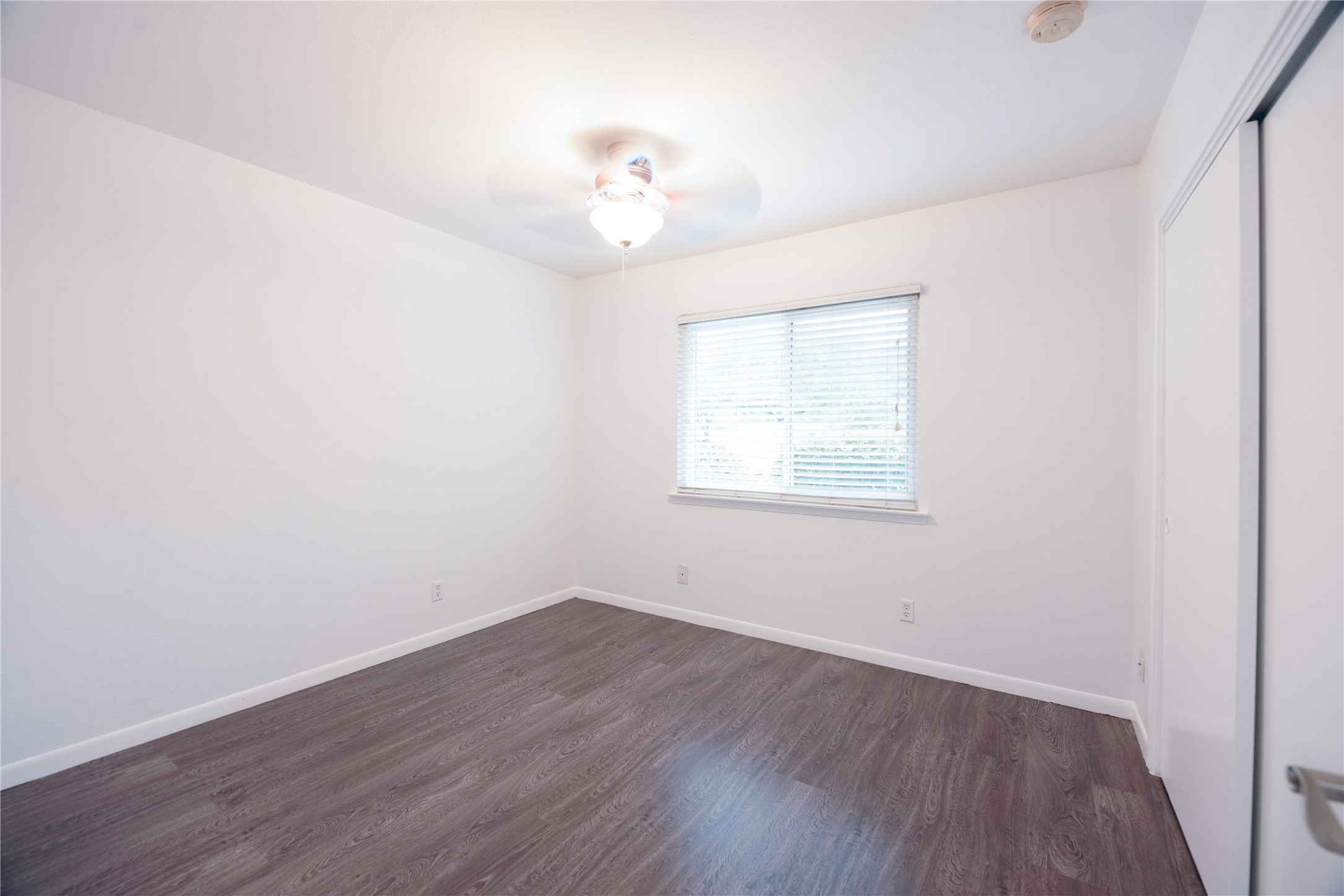 4209 Burnet Road, Unit 106 Austin, TX 78756 - Photo 14 of 17 wooden floor in an empty room with a window