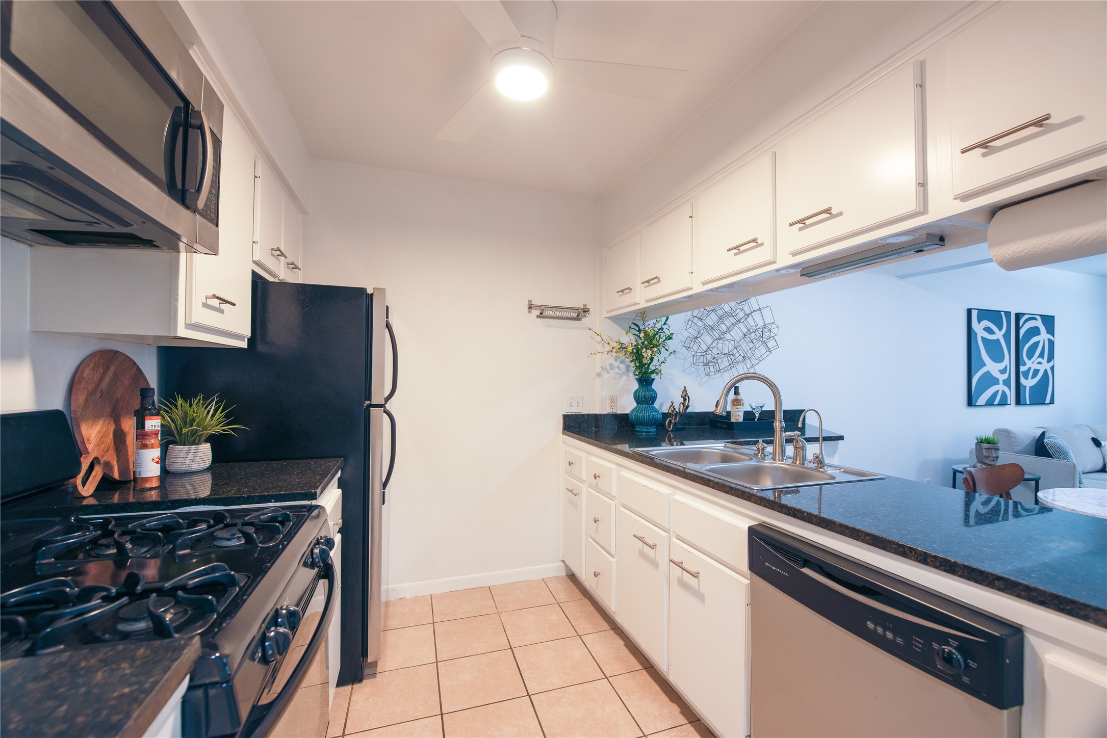 4209 Burnet Road, Unit 106 Austin, TX 78756 - Photo 3 of 17 a kitchen with stainless steel appliances granite countertop a sink stove and cabinets