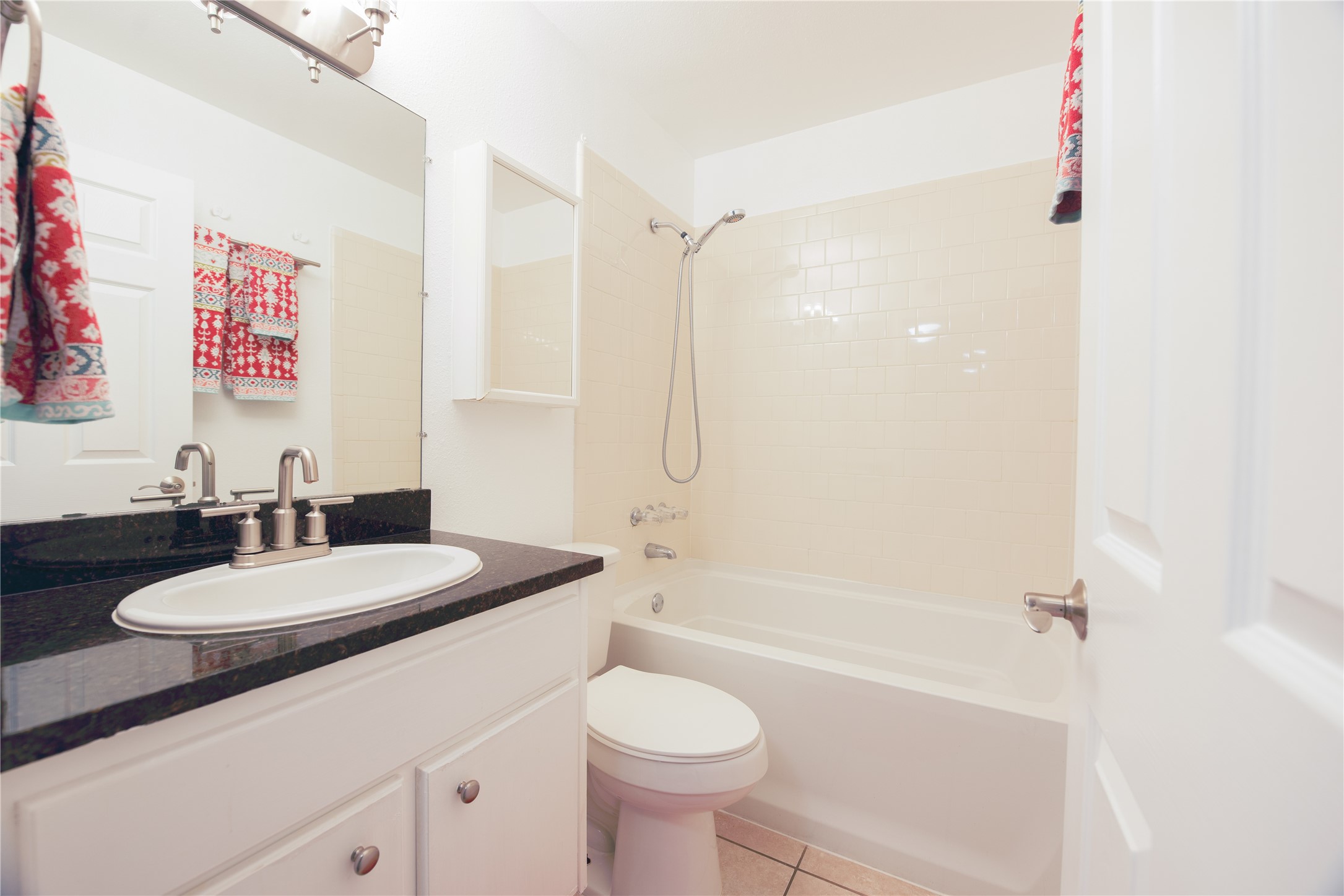 4209 Burnet Road, Unit 106 Austin, TX 78756 - Photo 5 of 17 a bathroom with a granite countertop sink toilet a mirror and shower