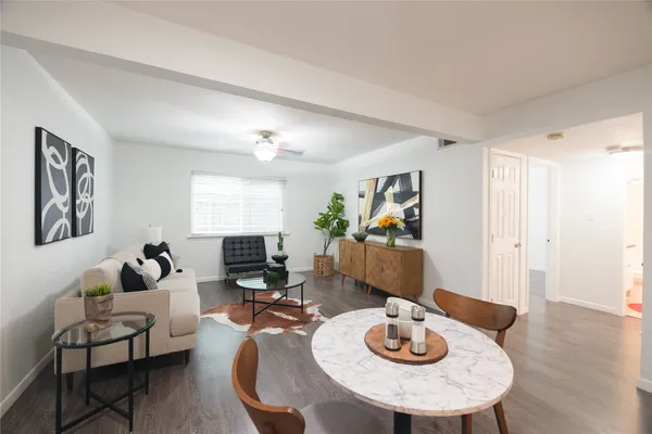 a view of a dining room with furniture and a kitchen view