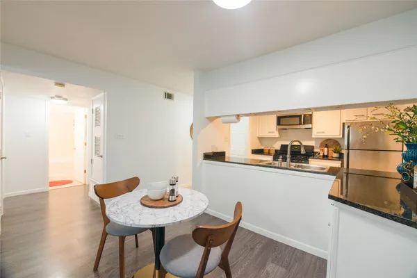 a dining room with furniture and wooden floor