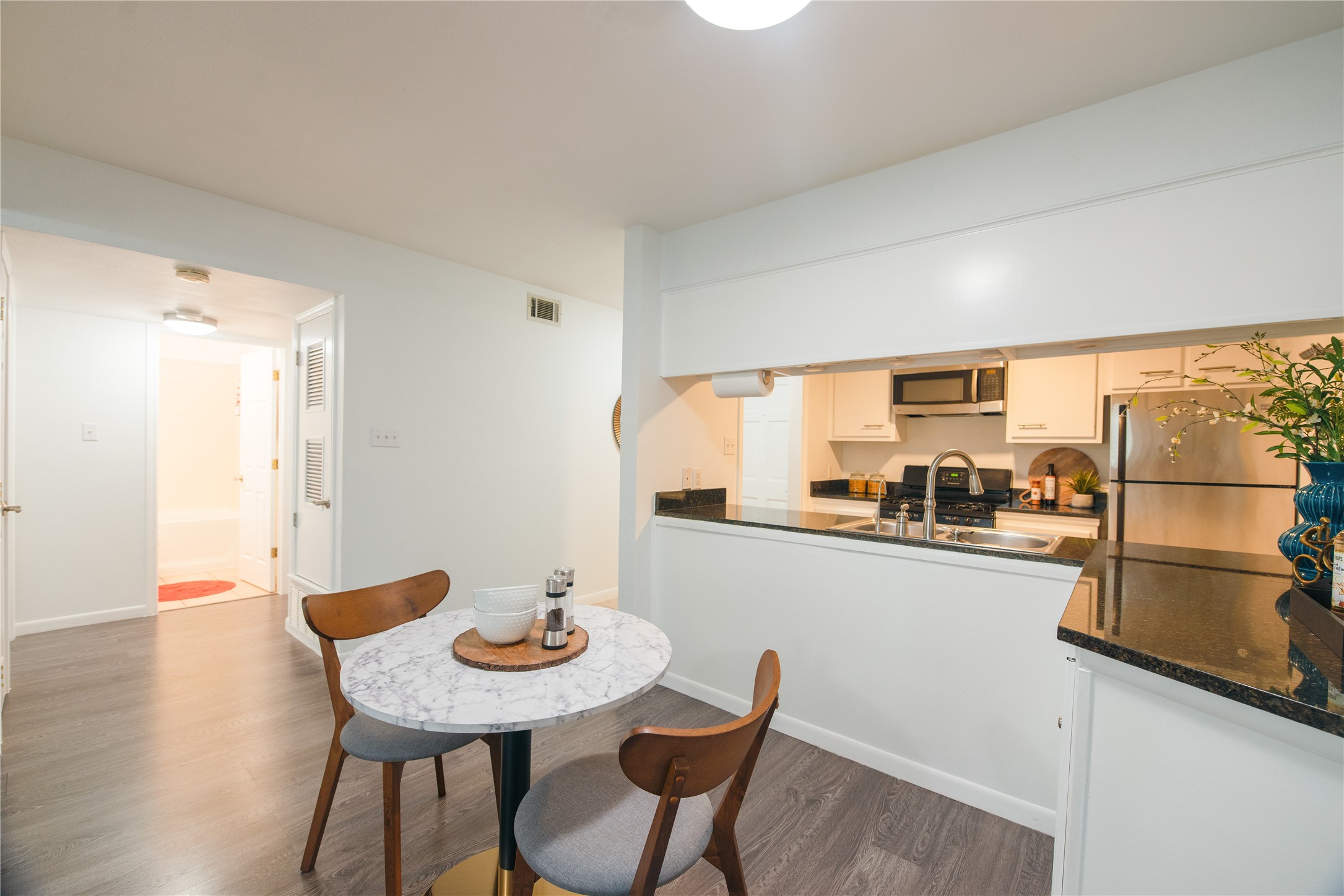 4209 Burnet Road, Unit 106 Austin, TX 78756 - Photo 8 of 17 a view of a dining room with furniture and a kitchen view