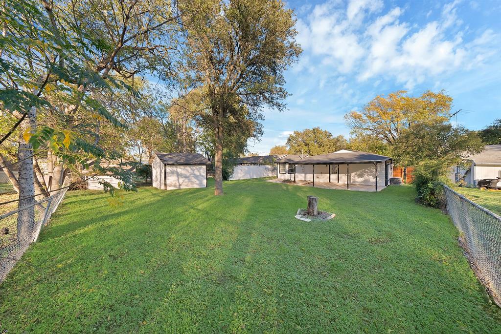 809 Hackamore Street White Settlement, TX 76108 - Photo 21 of 21 a view of a garden with a bench in the garden