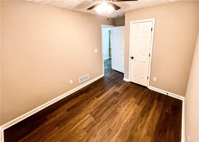 a view of a room with wooden floor and a sink