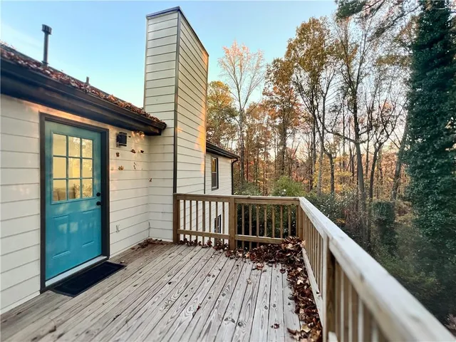 a view of balcony with wooden floor and fence