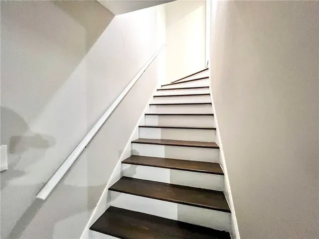 an empty room with a white walls and chandelier