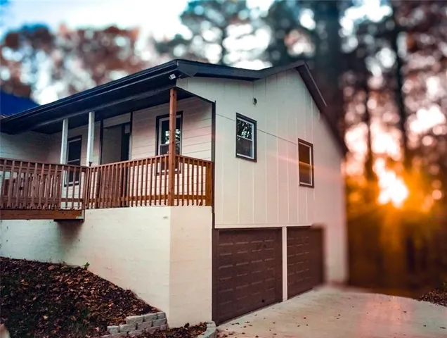 a front view of a house with a tree