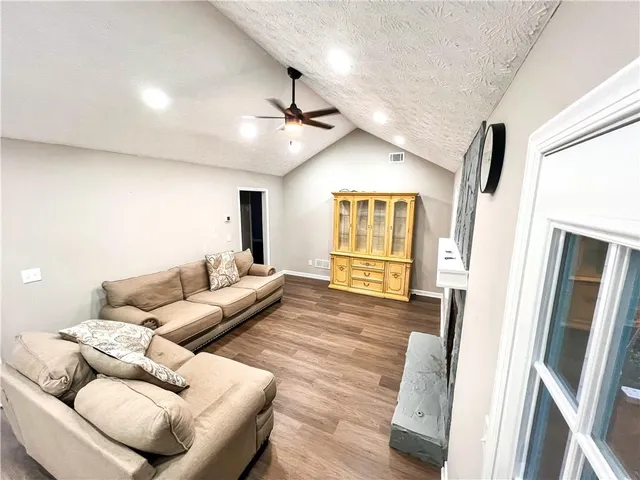 a living room with furniture and a fireplace