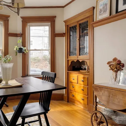 a view of a dining room with furniture window and wooden floor