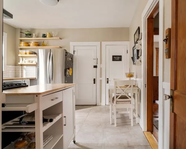 a kitchen with stainless steel appliances granite countertop white cabinets sink and a stove