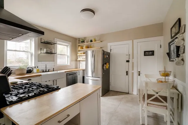 a kitchen with stainless steel appliances granite countertop a stove and a sink