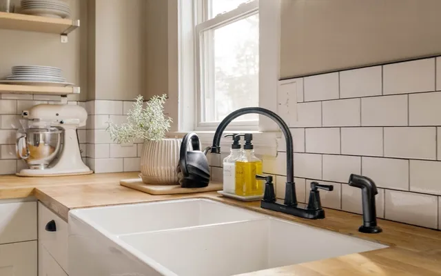 a view of a room that has a bed and a wooden floor