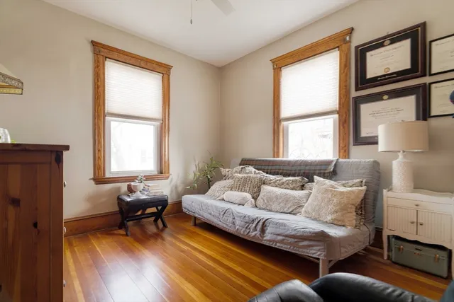 a view of a balcony with wooden chairs