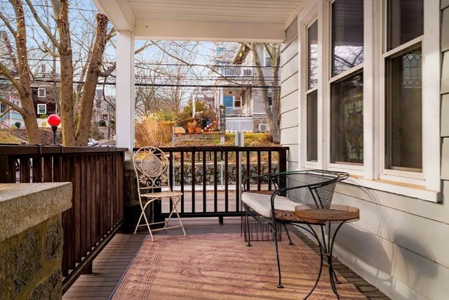 a front view of a building with large trees