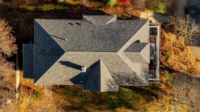 an aerial view of a house with a yard