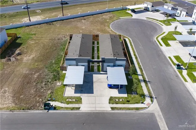 an aerial view of residential houses with outdoor space
