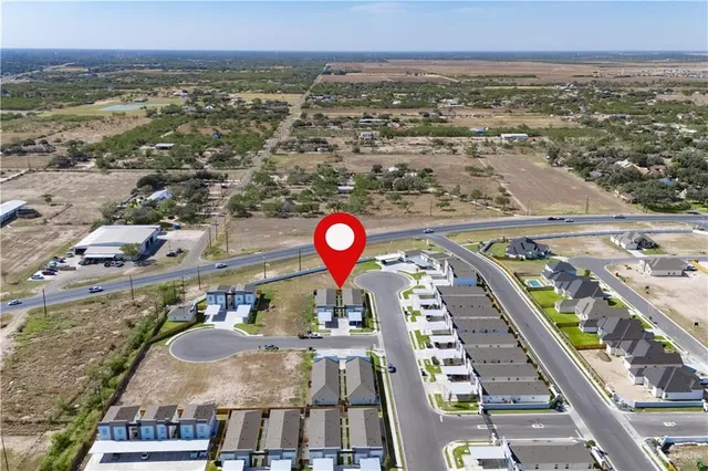 a view of a house with a swimming pool and a yard