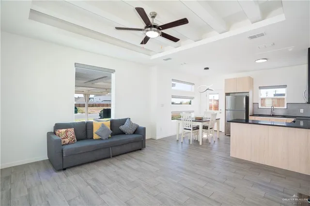 a living room with furniture and a wooden floor