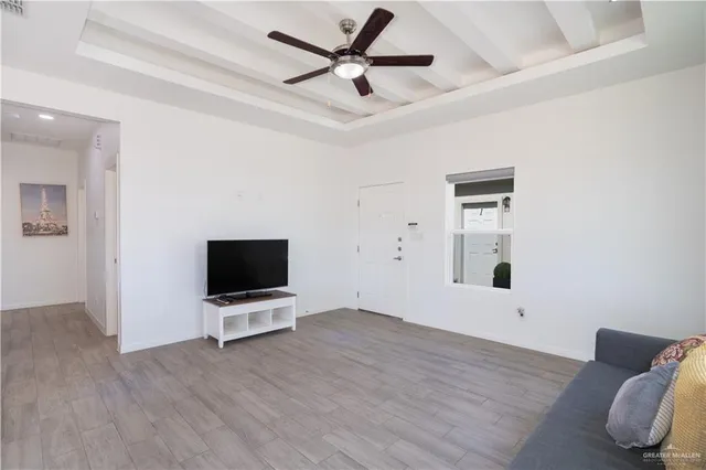 a view of workspace with wooden floor and ceiling fan