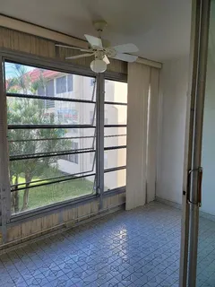 a view of a room with rack on the wall and a window