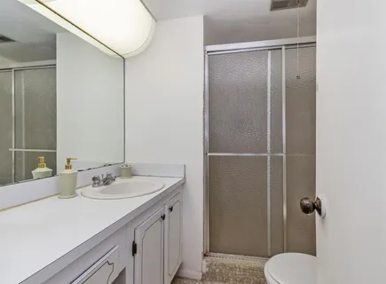 a bathroom with a sink toilet and shower