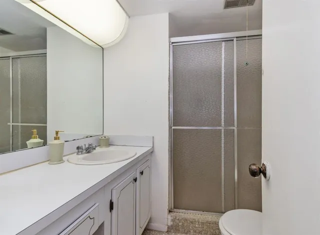 a bathroom with a sink toilet and shower